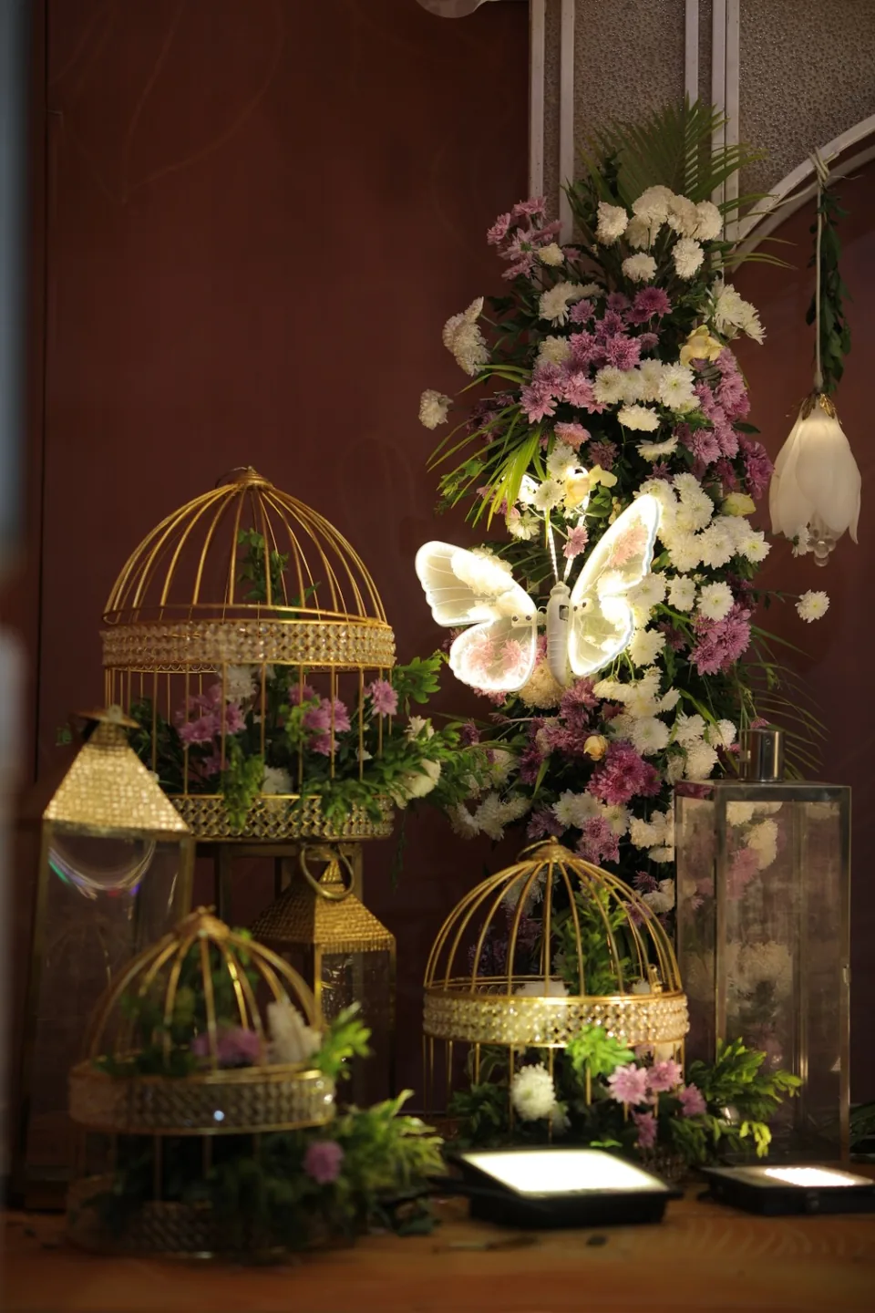 Floral detail with gilded birdcages, butterflies and soft blooms
