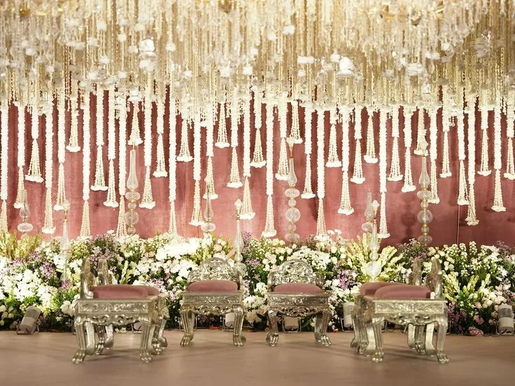 Grand stage with crystal strands, warm light and white florals