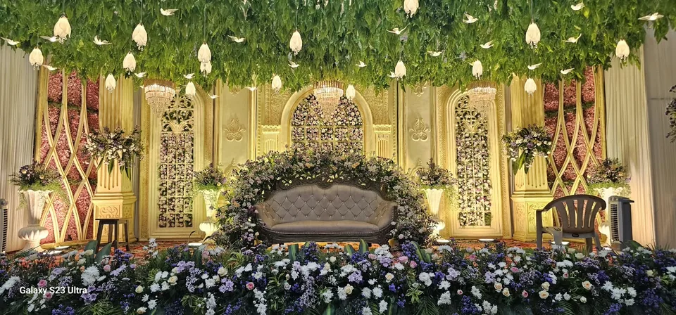 Grand ivory stage framed with lush greens and white blooms