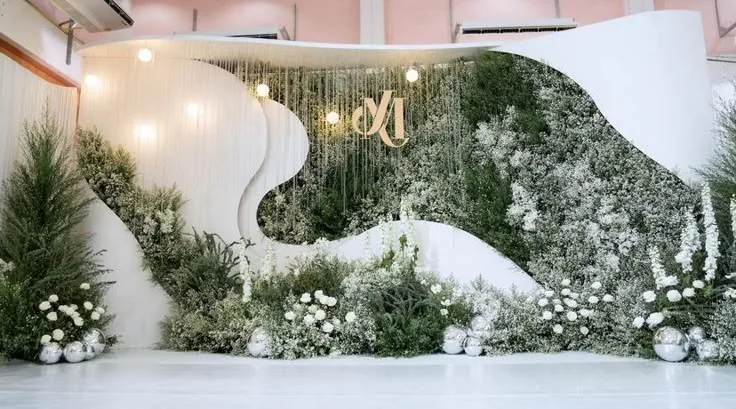 Modern wave backdrop with greenery wall and fresh white florals