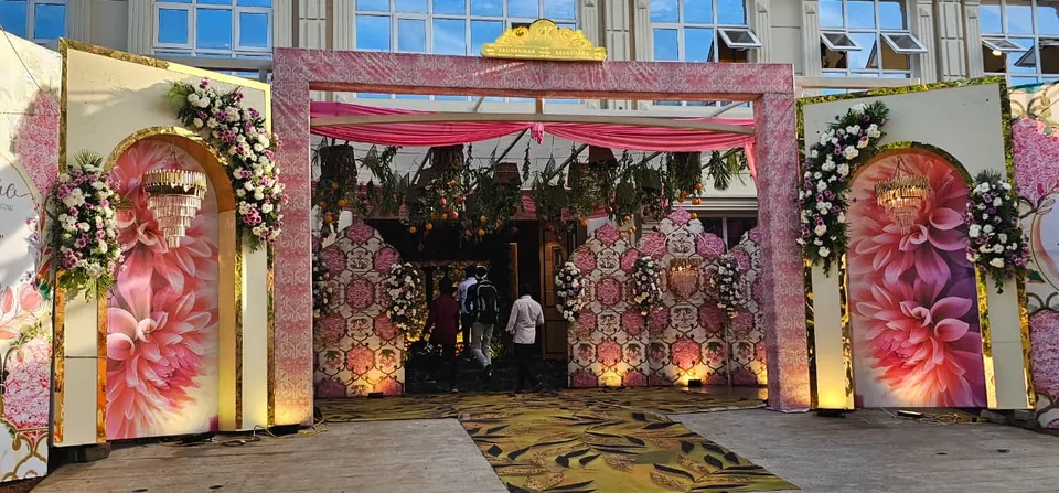 Outdoor entrance archway with blush florals and printed panels