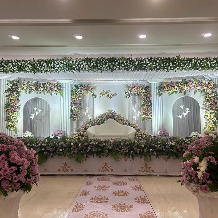 Soft pastel stage with arched niches and patterned aisle carpet