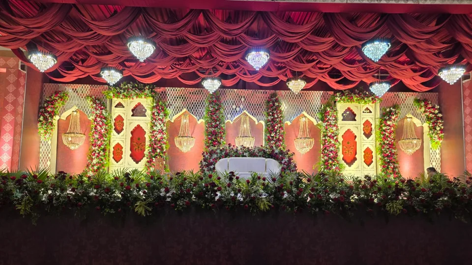 Royal red velvet stage with chandeliers and ornate panels