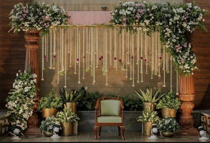 Rustic wood panel stage with hanging florals and brass planters