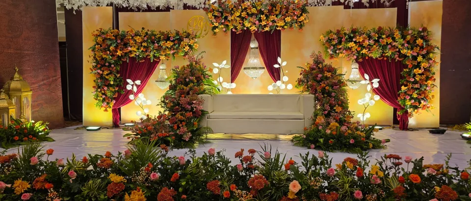 Vibrant stage with marigold tones and colourful fresh florals