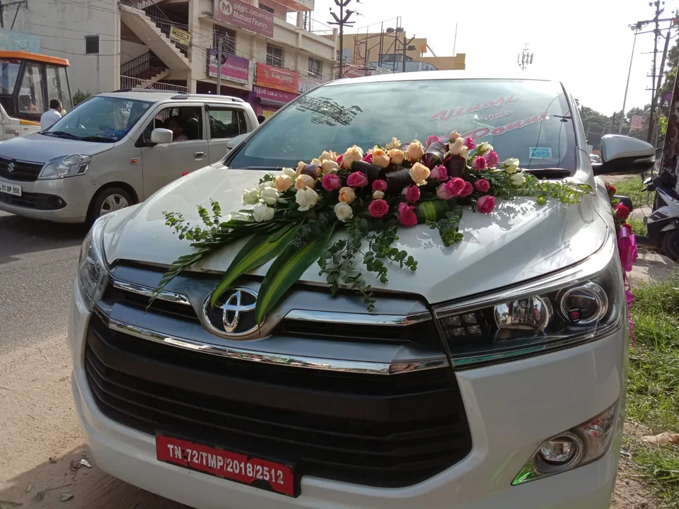 Wedding car with a full cascading floral arrangement on the bonnet